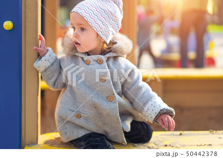 little cute girl playing at the playground in 50442378