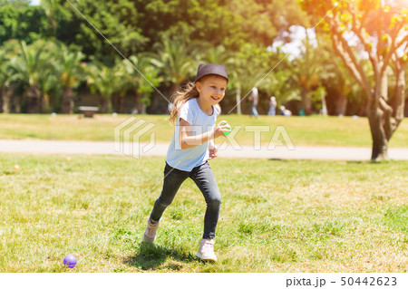happy baby smiling. Little girl running in the park 50442623