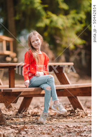 Little girl in outdoor park on her weekend Little girl in outdoor park on her weekend 50442654