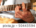 Guitar player strumming 50443594