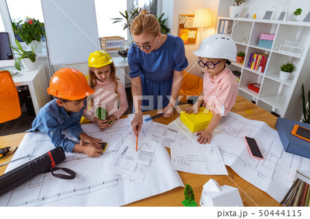Pupils listening to teacher speaking about house modeling Pupils listening to teacher speaking about house modeling 50444115