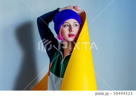 girl in 90s style jacket wrap up with yellow paper girl in 90s style jacket wrap up with yellow paper 50444523