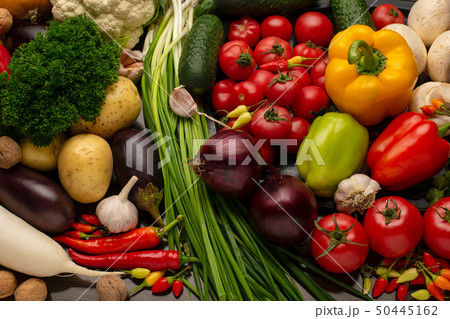 Vegetables and nuts on a brown wooden background Vegetables and nuts on a brown wooden background 50445162