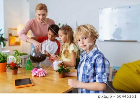 Blonde dark-eyed pupil feeling interested at the ecology lesson 50445351