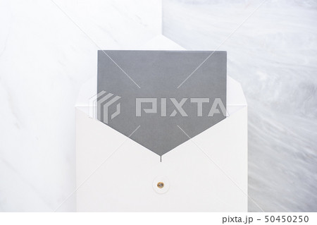 Top view of blank grey card in white envelop on Top view of blank grey card in white envelop on 50450250