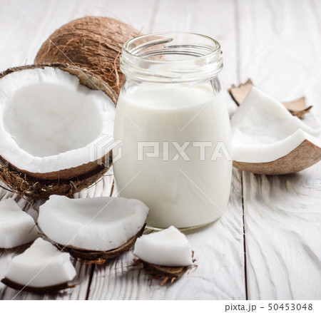 Milk or yogurt in mason jar on white wooden table Milk or yogurt in mason jar on white wooden table 50453048