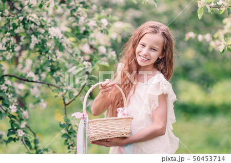 Adorable little girl in blooming apple garden on beautiful spring day 50453714