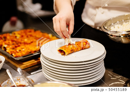 Woman preparing delicious mexican enchiladas 50455189