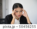Portrait of frustrated young woman holding hand on 50456255