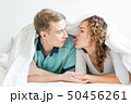 happy couple is lying in bed together. Enjoying 50456261