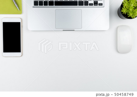 White office desk table with laptop and supplies. White office desk table with laptop and supplies. 50458749