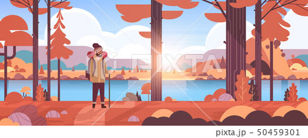 male tourist hiker with backpack man traveler holding stick standing in forest hiking concept 50459301