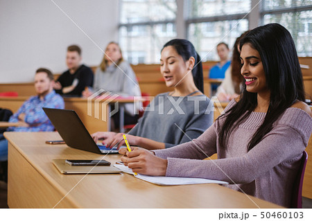 Multinational group of students in an auditorium 50460103