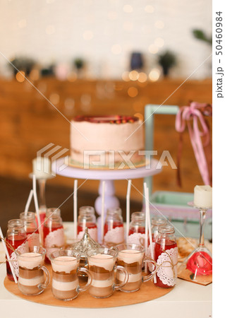 Tasty birthday big cake and yummy drinks on table. 50460984