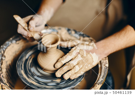 Potter modeling ceramic pot from clay on a Potter modeling ceramic pot from clay on a 50461139