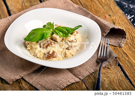 Homemade traditional Italian mushroom risotto on wooden table. 50461385