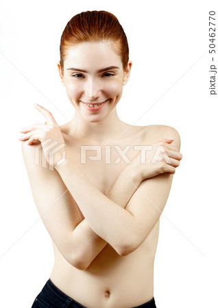 Lovely naked redhead woman covering her breast . 50462770