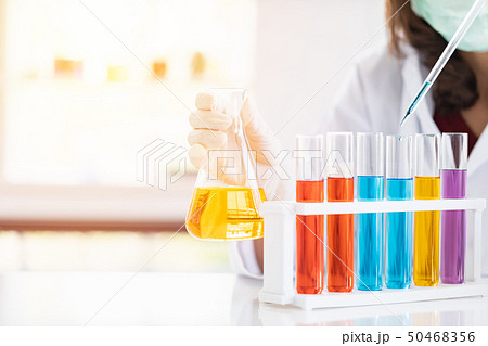 Scientist dropping liquid to petri dish.. Scientist dropping liquid to petri dish.. 50468356