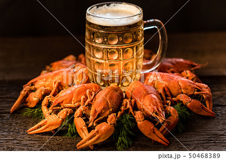 Boiled crayfish with beer on wooden background Boiled crayfish with beer on wooden background 50468389