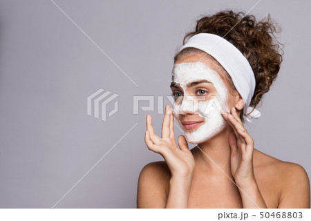 A portrait of a young woman with mask in a studio, beauty and skin care. 50468803