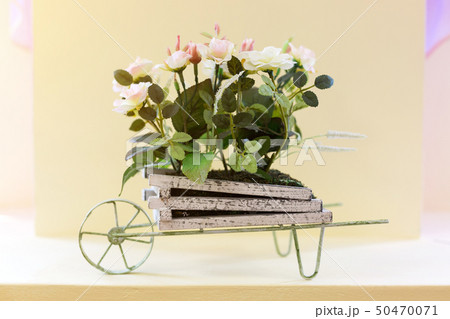 Arrangement of artificial flowers in a bed on 50470071