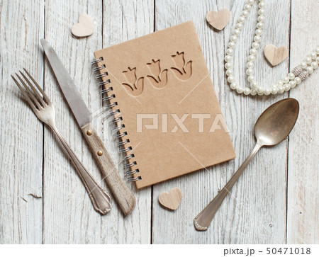 Background with notebook, fork, knife and spoon Background with notebook, fork, knife and spoon 50471018