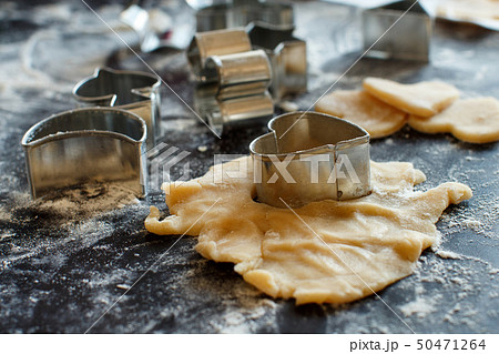 Close up of cookie cutters in a dough Close up of cookie cutters in a dough 50471264