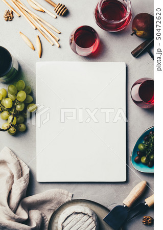 Red wine with charcuterie assortment on rustic concrete background Red wine with charcuterie assortment on rustic concrete background 50472620