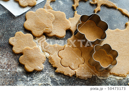 Cooking cookies with flower cookie cutters Cooking cookies with flower cookie cutters 50473173