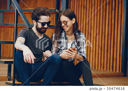 Couple sitting with phone Couple sitting with phone 50474616