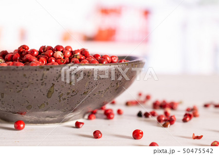 Pink peruvian pepper with kitchen behind Pink peruvian pepper with kitchen behind 50475542