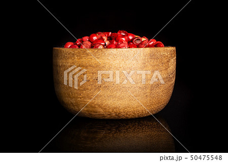 Pink peruvian pepper isolated on black glass 50475548