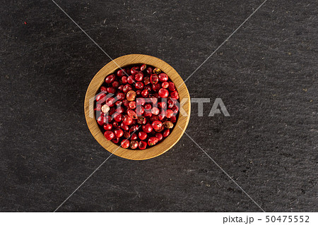 Pink peruvian pepper on grey stone Pink peruvian pepper on grey stone 50475552