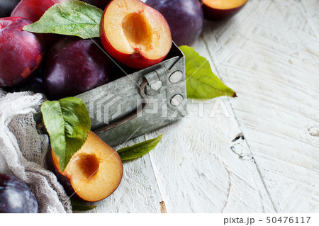 Fresh plums with leaves Stock Photo by katrinshine