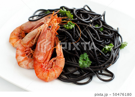 Squid ink pasta with prawns and tomatoes 50476180