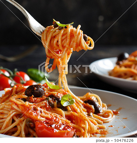 Spaghetti with tomato sauce olives and capers 50476226