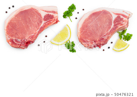 sliced raw pork meat with parsley and lemon isolated on white background with copy space for your 50476321