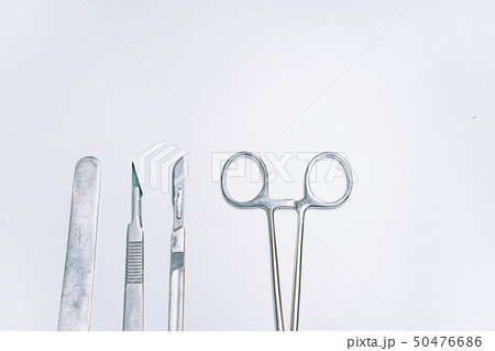 Scapula for throat, two scalpels and clamp on a light background 50476686