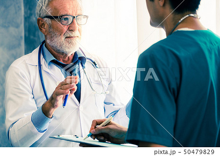 Senior male doctor working with another doctor. Senior male doctor working with another doctor. 50479829