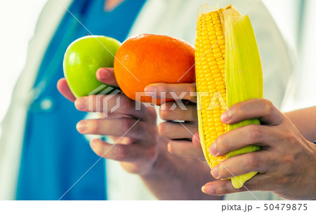 Group of nutritionist presenting healthy diet food Group of nutritionist presenting healthy diet food 50479875