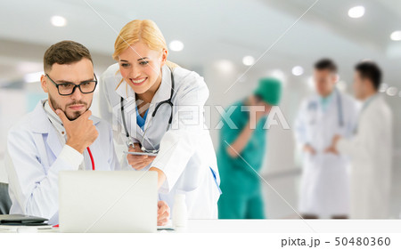 Doctor working in hospital with other doctors. 50480360