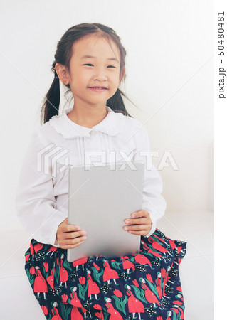 Little kid on white background with tablet. Little kid on white background with tablet. 50480481