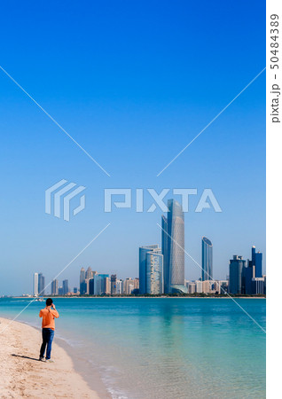 Tourists on beach at marina island with modern Abu 50484389