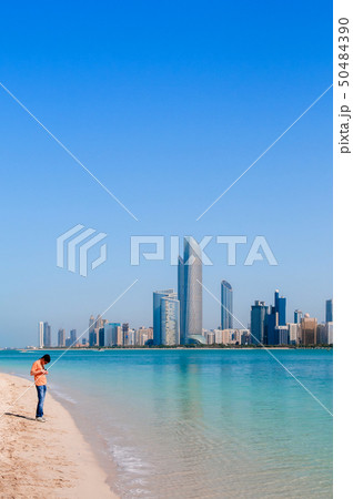 Tourists on beach at marina island with modern Abu Tourists on beach at marina island with modern Abu 50484390