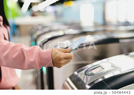 Woman scan train ticket to subway entrance gate 50484443