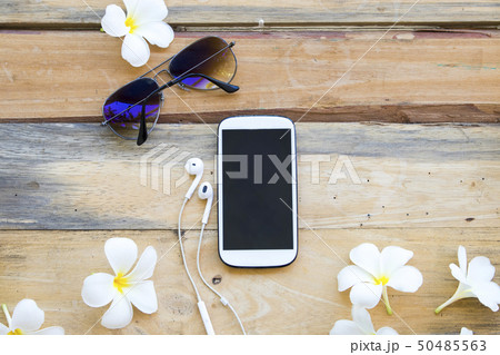 mobile phone and sunglasses of lifestyle woman 50485563
