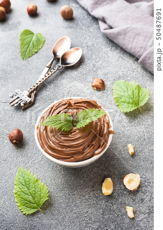 Nougat nut chocolate in a plate on a dark concrete 50487691