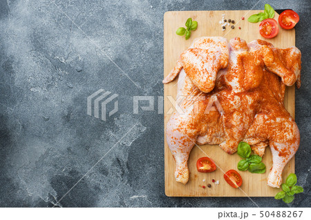 Raw chicken tobacco on a wooden Board with spices  50488267