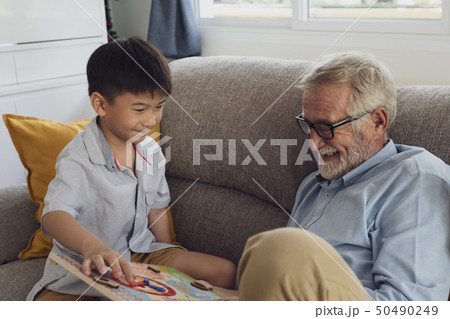 senior man happiness and grandson are sitting on senior man happiness and grandson are sitting on 50490249