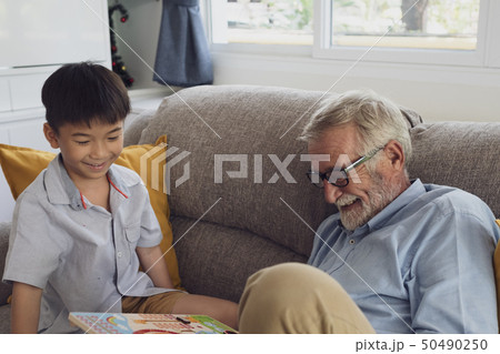 senior man happiness and grandson are sitting on senior man happiness and grandson are sitting on 50490250